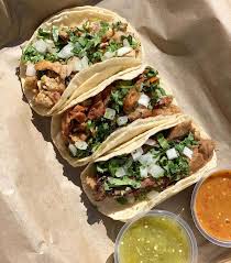 Bocca Taqueria signature dishes  Gourmet Tacos (e.g., Carnitas, Al Pastor, Short Rib), Street Corn, Queso Fundido, various fresh Salsas and Guacamole.